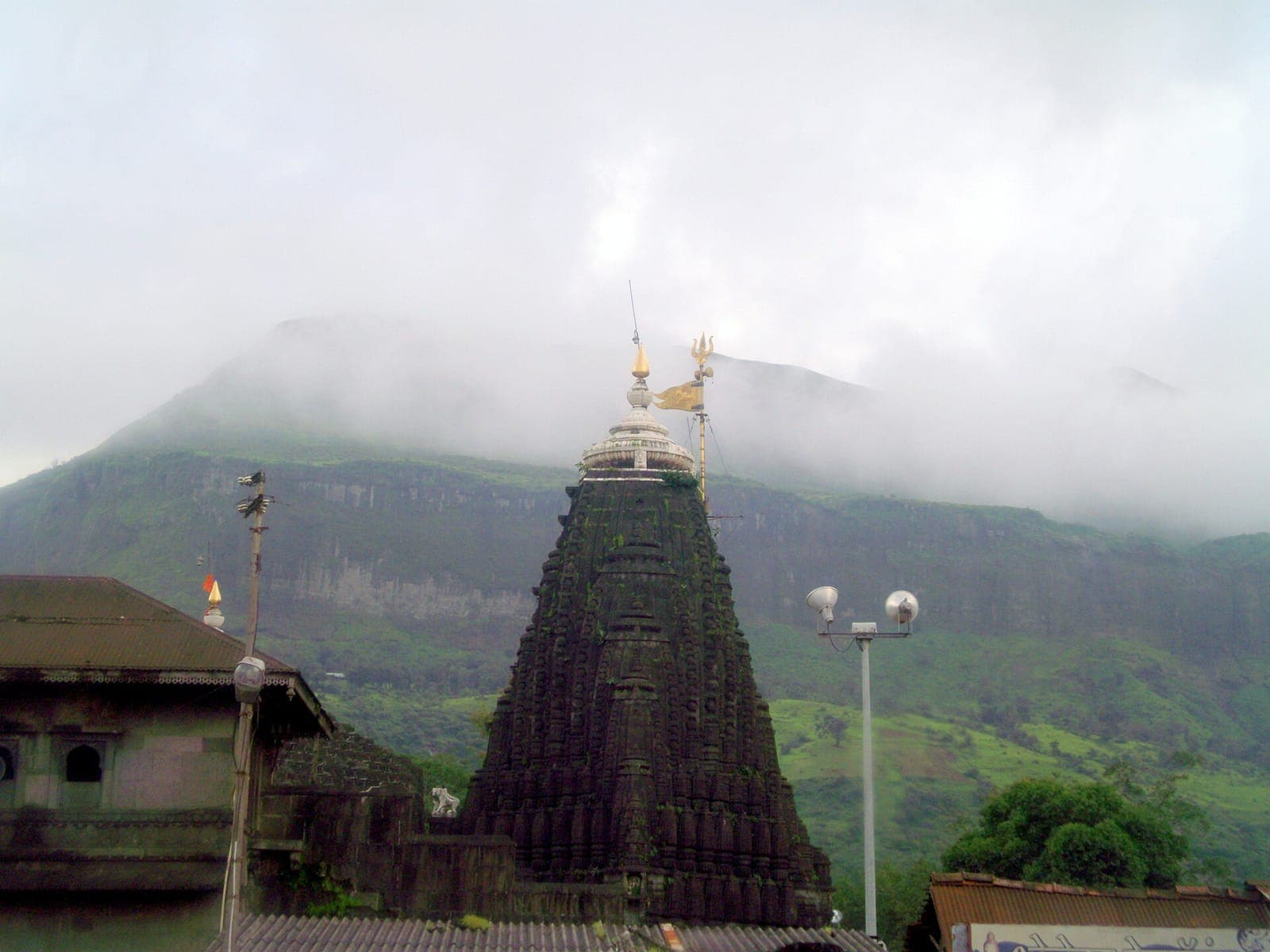 Trimbakeshwar temple spire with the misty Brahmagiri hills behind