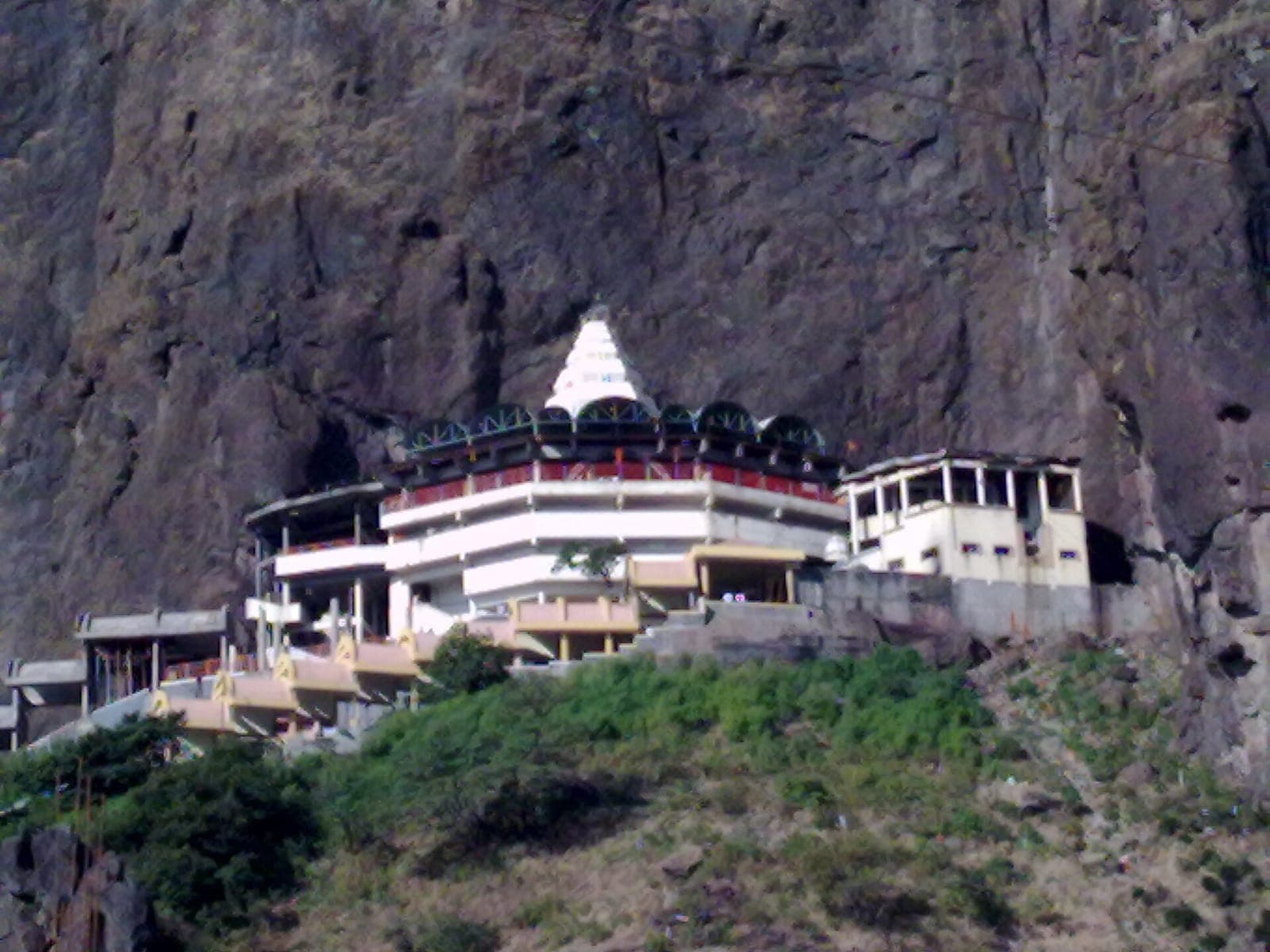 Saptashrungi Devi temple beneath the cliffs of Saptashrungi Gad